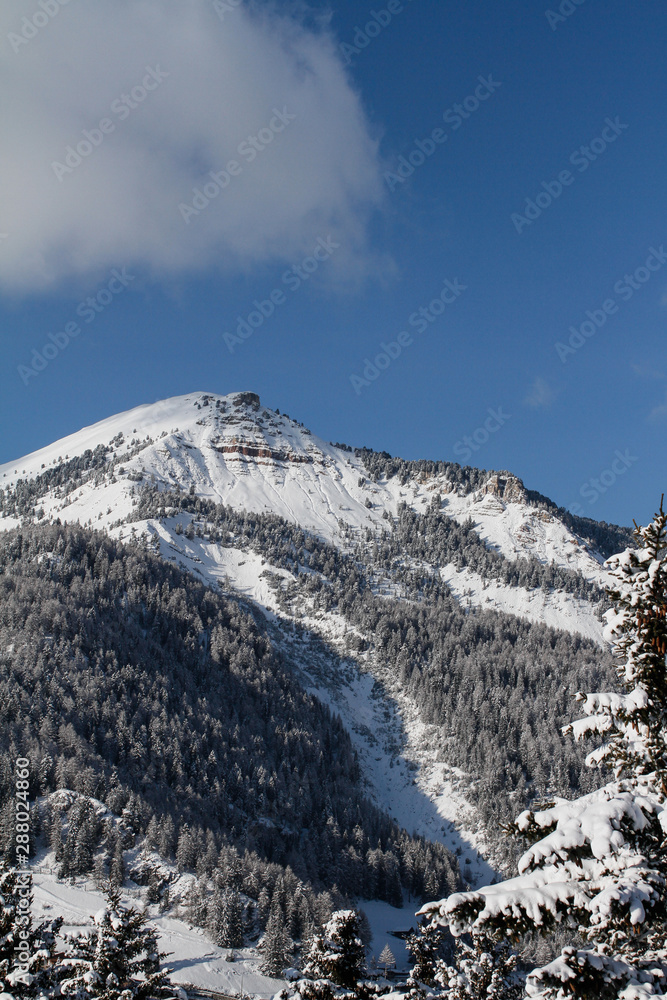 Pic covered in Snow. Mountain in the Dolomites in Val Gardena seen from La Selva in Wolkenstein in Gröden. Winter Landscape