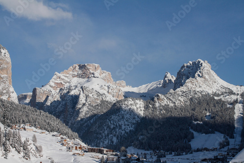 Selva Val Gardena in Winter, with the Cirspitzen and Crespeina in the Background. Majestic Mountains above Wolkenstein in Gröden covered in Snow photo