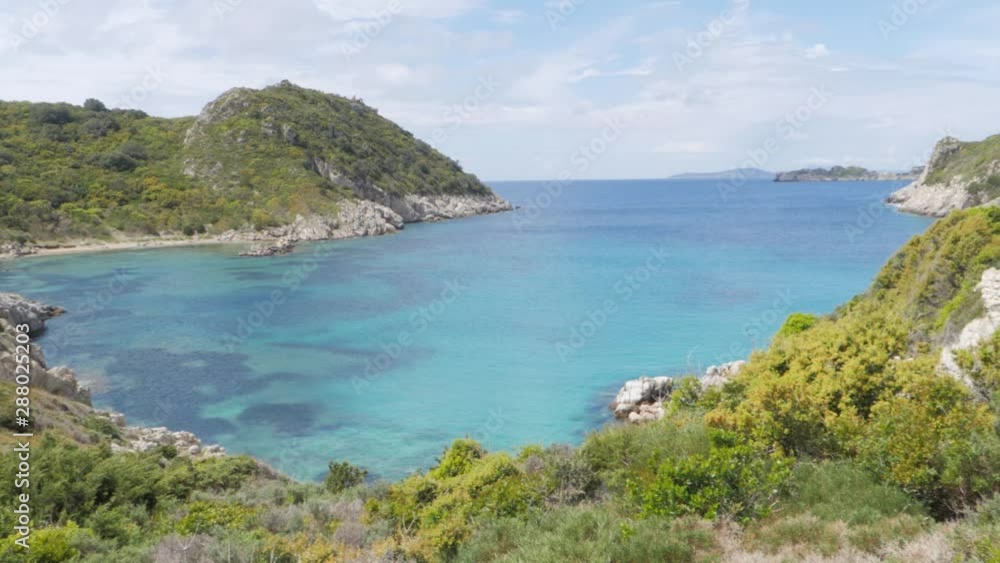 Panoramic View of Afionas Beach, Kerkyra, Greece. Amazing hidden bay immerses in lush Mediterranean vegetation and crystal clear seawater. Panoramic View of Afionas Beach, Kerkyra, Greece. Amazing hidden bay immerses in lush Mediterranean vegetation and crystal clear seawater.
