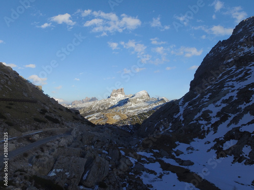 Aerial of Monte Averau in the Dolomites above Passo Falzarego. MonteAverau in the Sun, looking through a dark Valley in Shadow