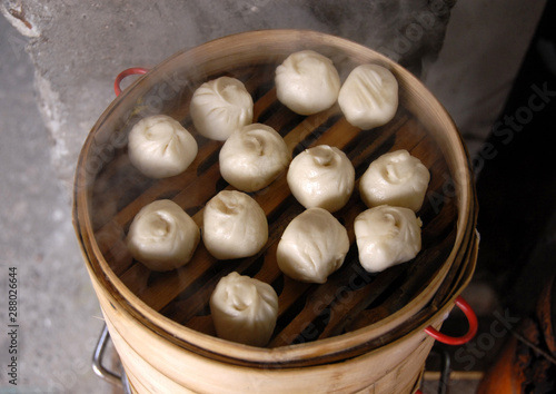 Chinese dumplings in Xitang water town near Shanghai. This is typical Chinese street food. These are steamed dumplings and are popular for lunch in China. Dumplings are a favorite Chinese food. photo