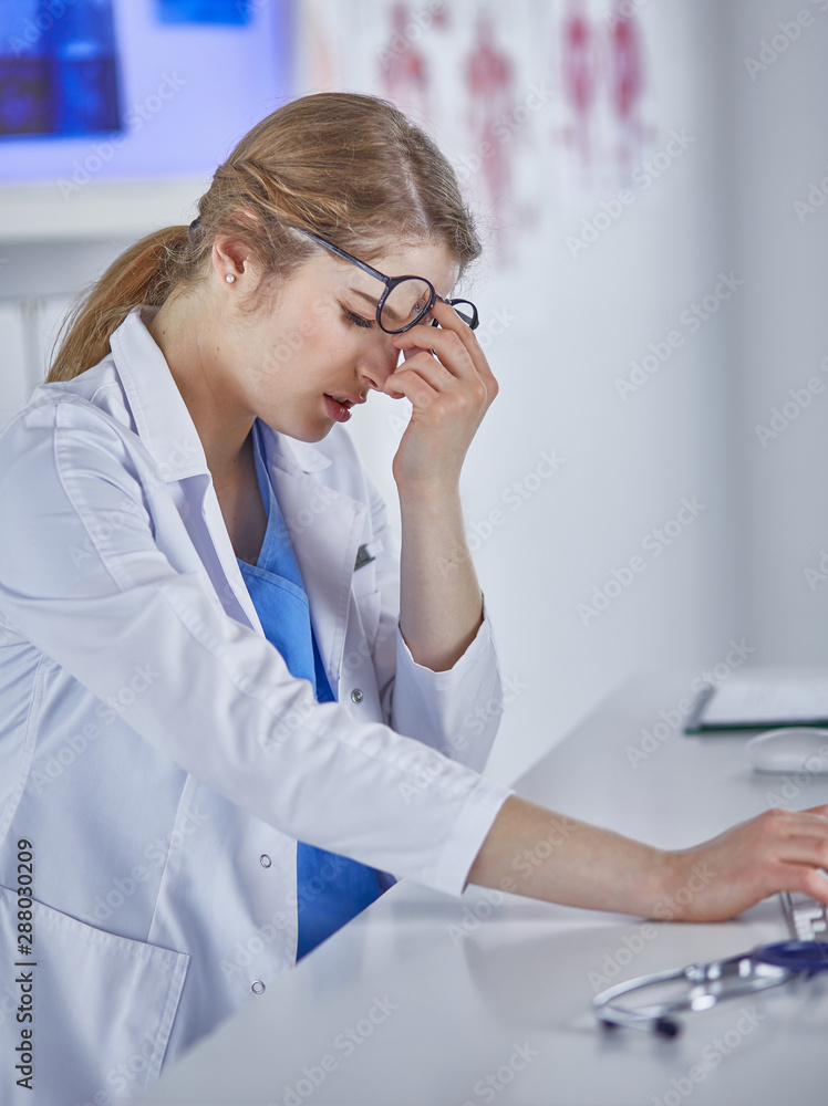 Young female doctor tired after working with computer Young female doctor tired after working with computer