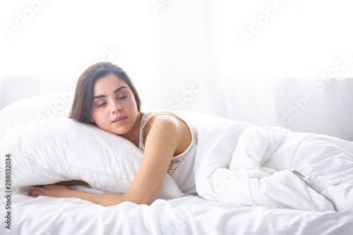 beautiful young woman basking in bed in the morning. Beautiful