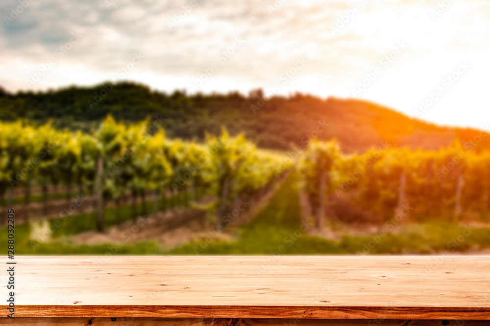 Autumn vineyard withs unset. Empty space on wooden table for products, deoration or text. Autumn vineyard withs unset. Empty space on wooden table for products, deoration or text.