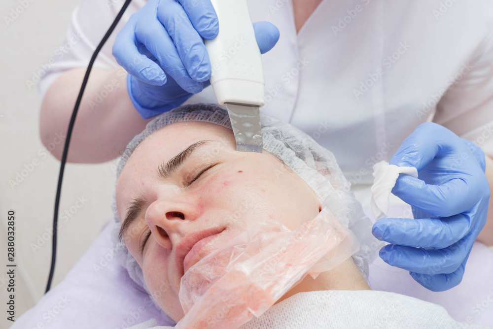 woman getting ultrasound skin cleaning at beauty salon woman getting ultrasound skin cleaning at beauty salon