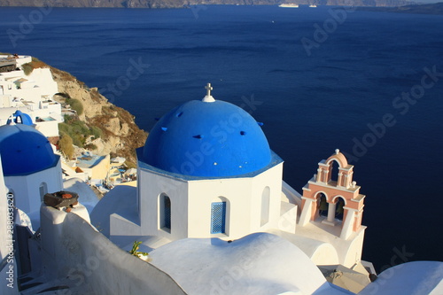 Blue church domes and white buildings in Oia