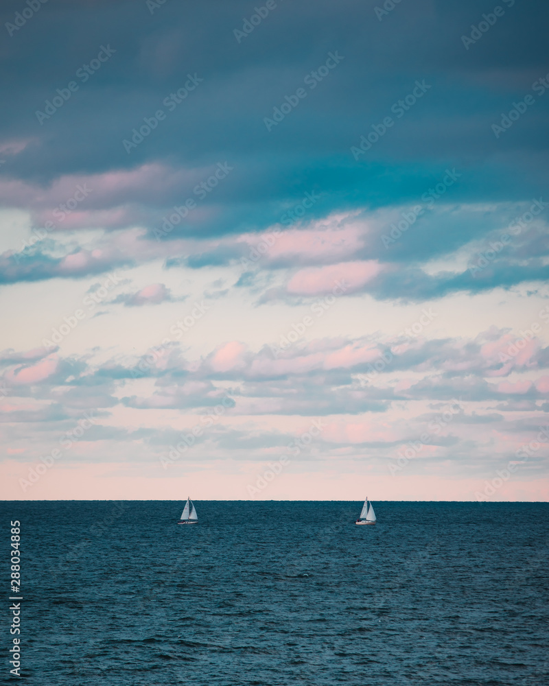Sailboats out on the lake during sunset