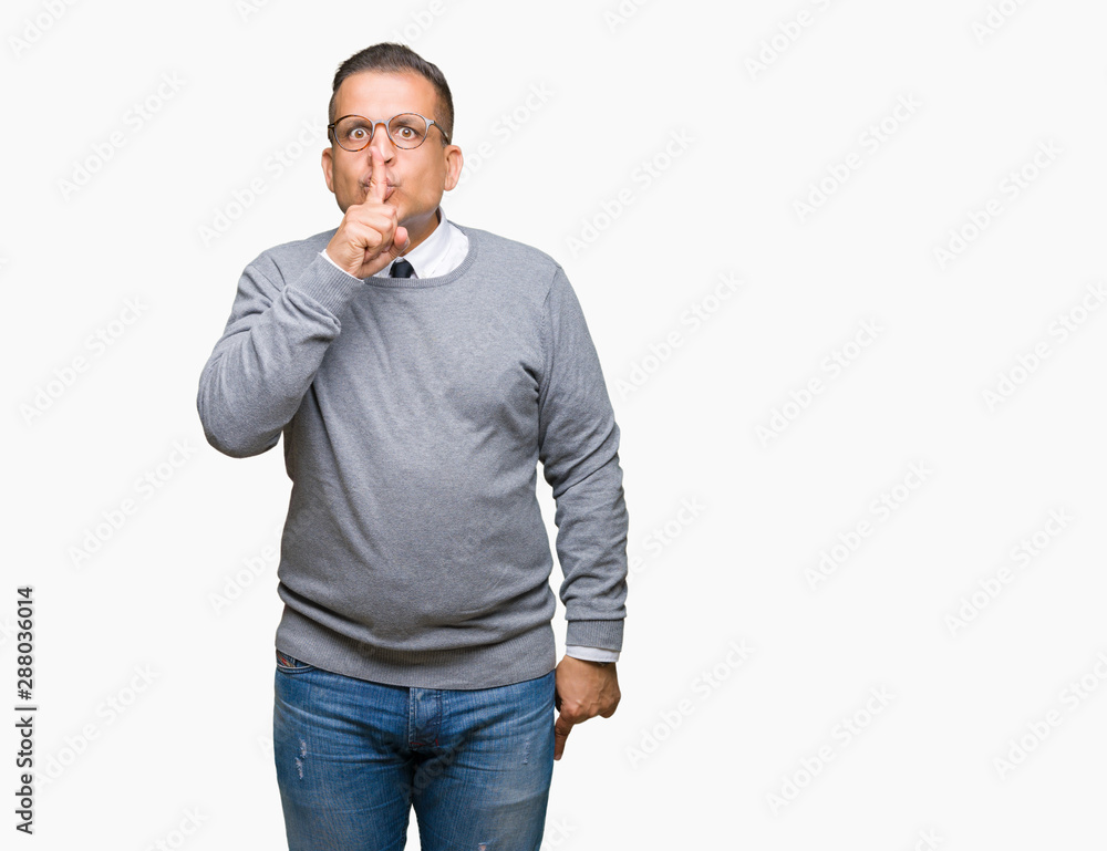 Middle age bussines arab man wearing glasses over isolated background asking to be quiet with finger on lips. Silence and secret concept. Middle age bussines arab man wearing glasses over isolated background asking to be quiet with finger on lips. Silence and secret concept.