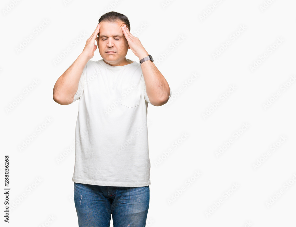 Fototapeta premium Middle age arab man wearig white t-shirt over isolated background with hand on head for pain in head because stress. Suffering migraine.
