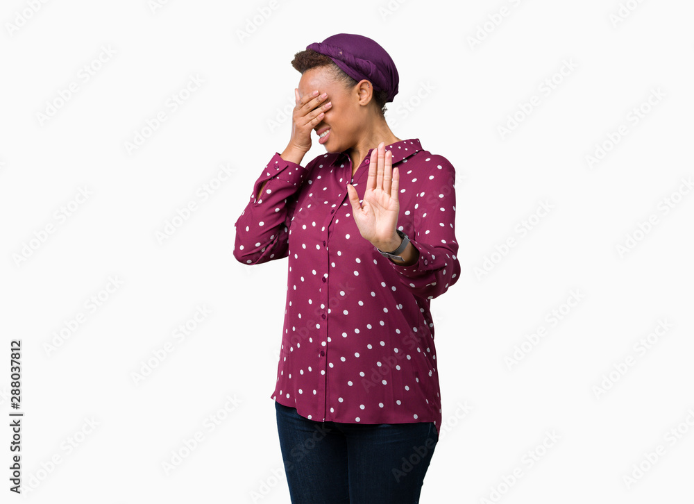 Beautiful young african american woman wearing head scarf over isolated background covering eyes with hands and doing stop gesture with sad and fear expression. Embarrassed and negative concept. Beautiful young african american woman wearing head scarf over isolated background covering eyes with hands and doing stop gesture with sad and fear expression. Embarrassed and negative concept.
