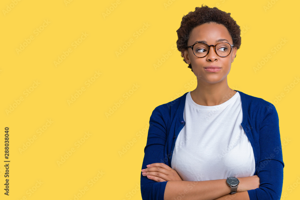 Young beautiful african american woman wearing glasses over isolated background smiling looking side and staring away thinking. Young beautiful african american woman wearing glasses over isolated background smiling looking side and staring away thinking.