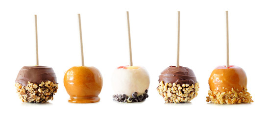 Variety of autumn candy apples with caramel, chocolate and nuts isolated on a white background
