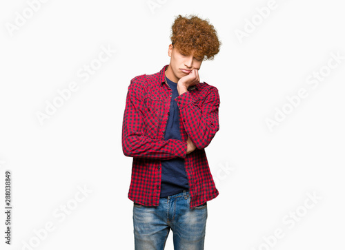 Young handsome student man with afro hair wearing a jacket thinking looking tired and bored with depression problems with crossed arms.