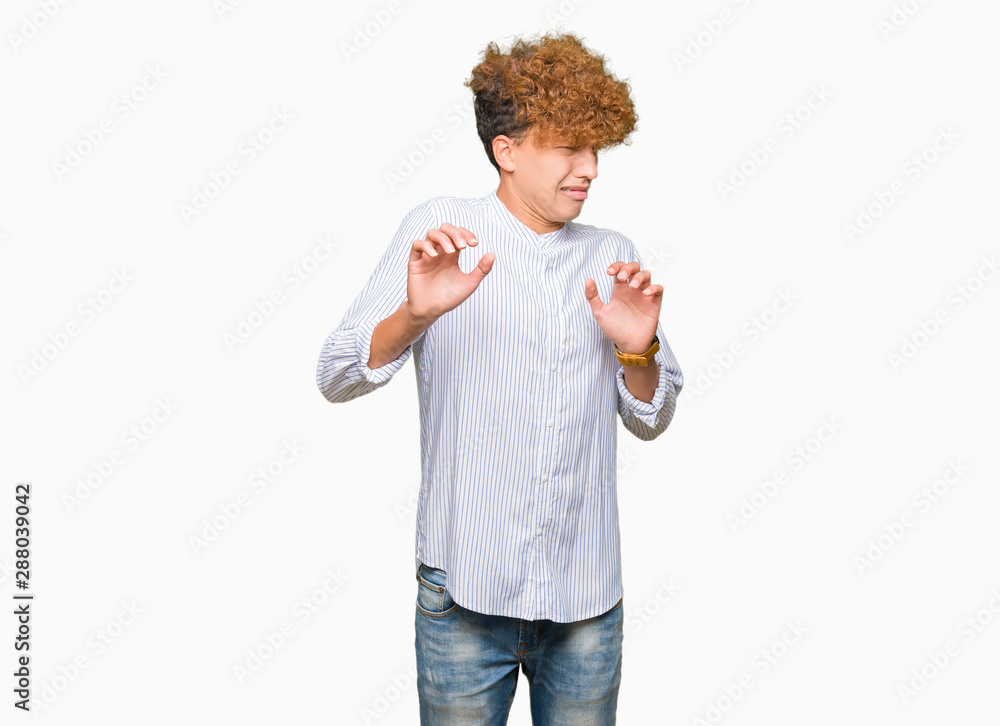 Young handsome business man with afro hair wearing elegant shirt disgusted expression, displeased and fearful doing disgust face because aversion reaction. With hands raised. Annoying concept. Young handsome business man with afro hair wearing elegant shirt disgusted expression, displeased and fearful doing disgust face because aversion reaction. With hands raised. Annoying concept.