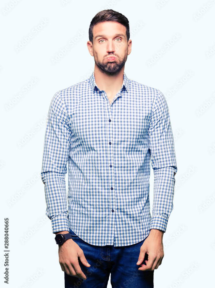 Handsome business man with blue eyes puffing cheeks with funny face. Mouth inflated with air, crazy expression. Handsome business man with blue eyes puffing cheeks with funny face. Mouth inflated with air, crazy expression.