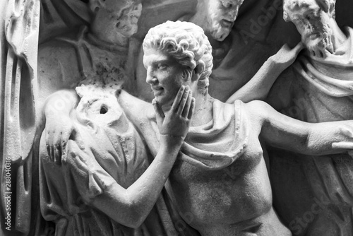 Photos Black and white photo of marble sculptures showing a man hugging a headless fema