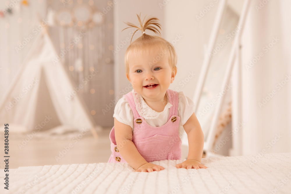 baby girl in the nursery playing,bright children's room, textiles for children's room baby girl in the nursery playing,bright children's room, textiles for children's room