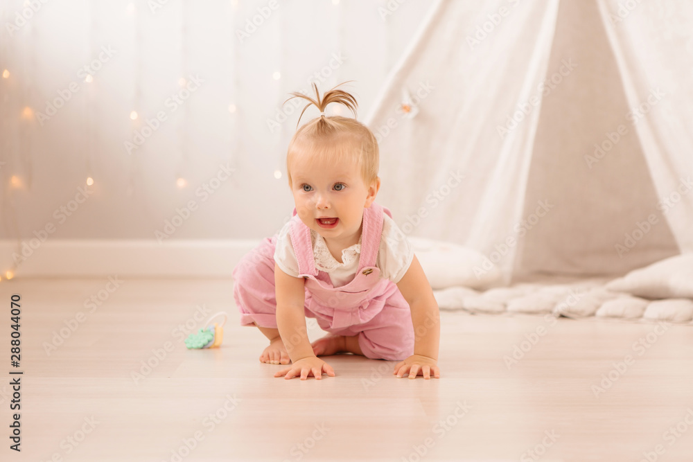 baby girl in the nursery playing,bright children's room, textiles for children's room baby girl in the nursery playing,bright children's room, textiles for children's room