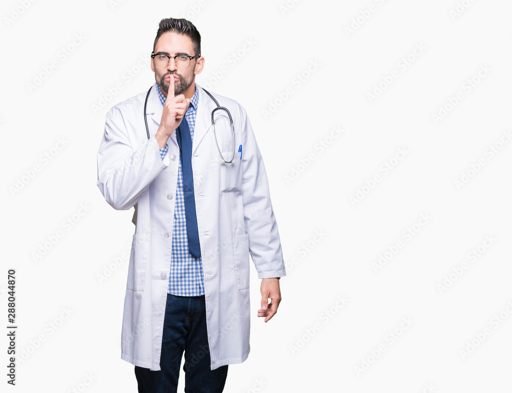 Handsome young doctor man over isolated background asking to be quiet with finger on lips. Silence and secret concept. Handsome young doctor man over isolated background asking to be quiet with finger on lips. Silence and secret concept.