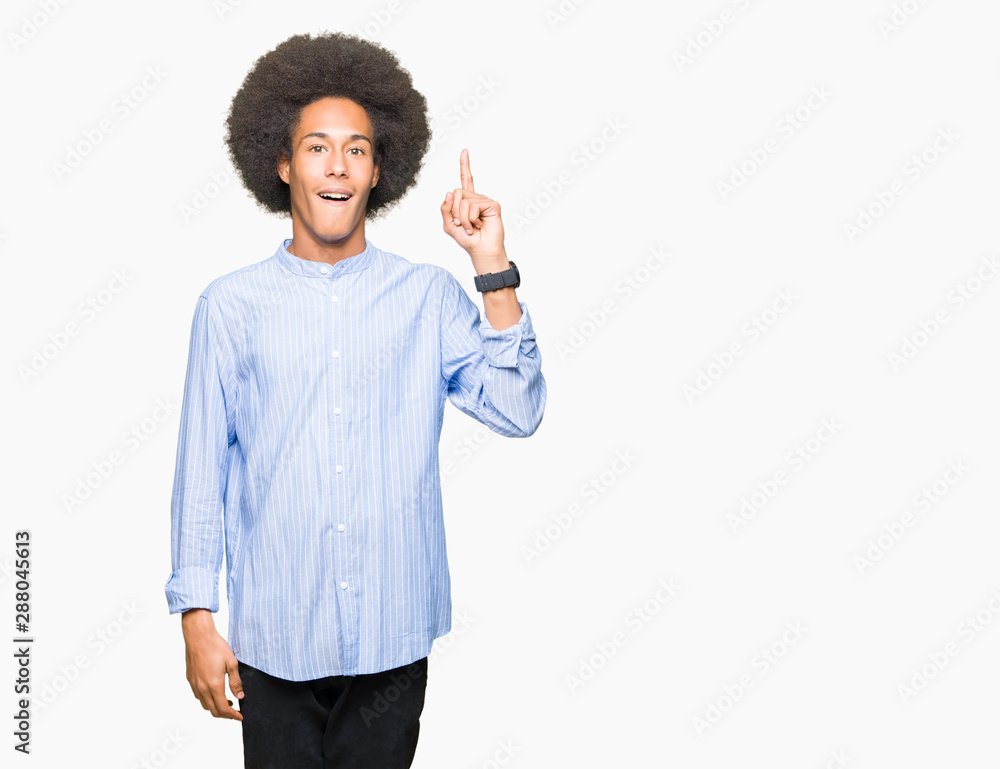 Young african american man with afro hair pointing finger up with successful idea. Exited and happy. Number one. Young african american man with afro hair pointing finger up with successful idea. Exited and happy. Number one.