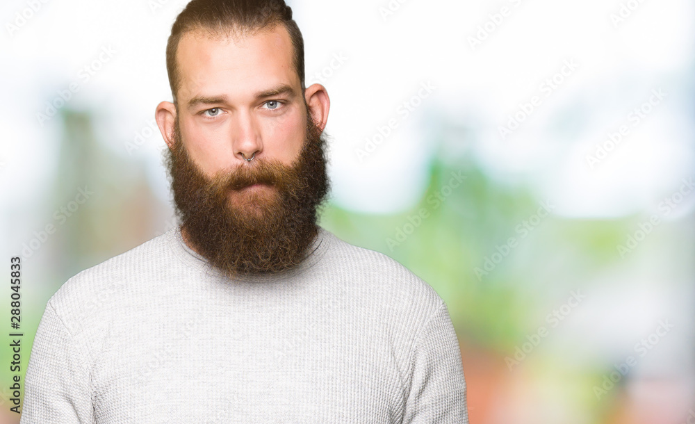 Young blond man wearing casual sweater Relaxed with serious expression on face. Simple and natural looking at the camera. Young blond man wearing casual sweater Relaxed with serious expression on face. Simple and natural looking at the camera.