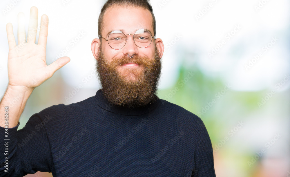 Young blond man wearing glasses and turtleneck sweater Waiving saying hello happy and smiling, friendly welcome gesture Young blond man wearing glasses and turtleneck sweater Waiving saying hello happy and smiling, friendly welcome gesture