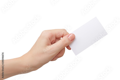 Female hand holding blank paper business card isolated on white © Halyna