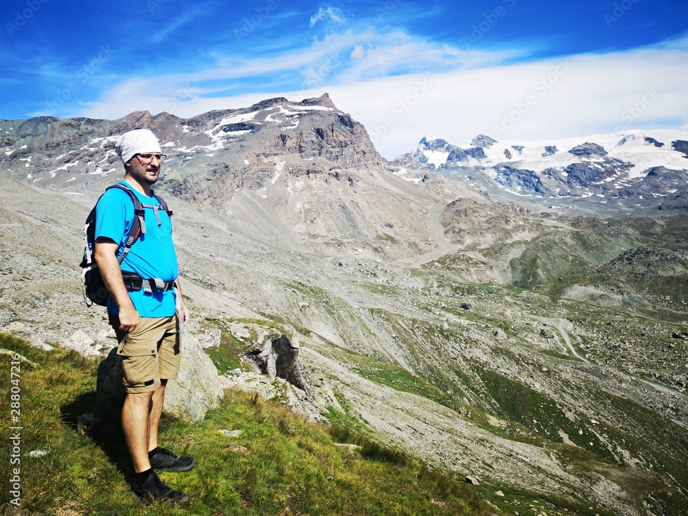 Hiker with Furgghorn and Plateau Monte Rosa in the background Hiker with Furgghorn and Plateau Monte Rosa in the background