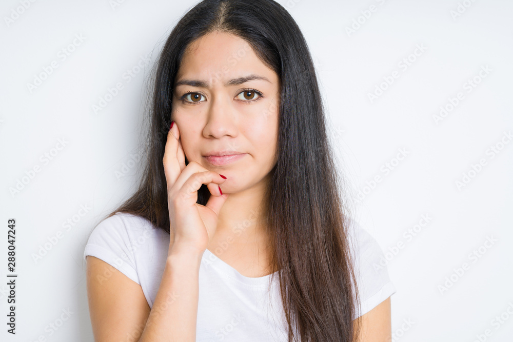 Beautiful brunette woman over isolated background thinking looking tired and bored with depression problems with crossed arms. Beautiful brunette woman over isolated background thinking looking tired and bored with depression problems with crossed arms.