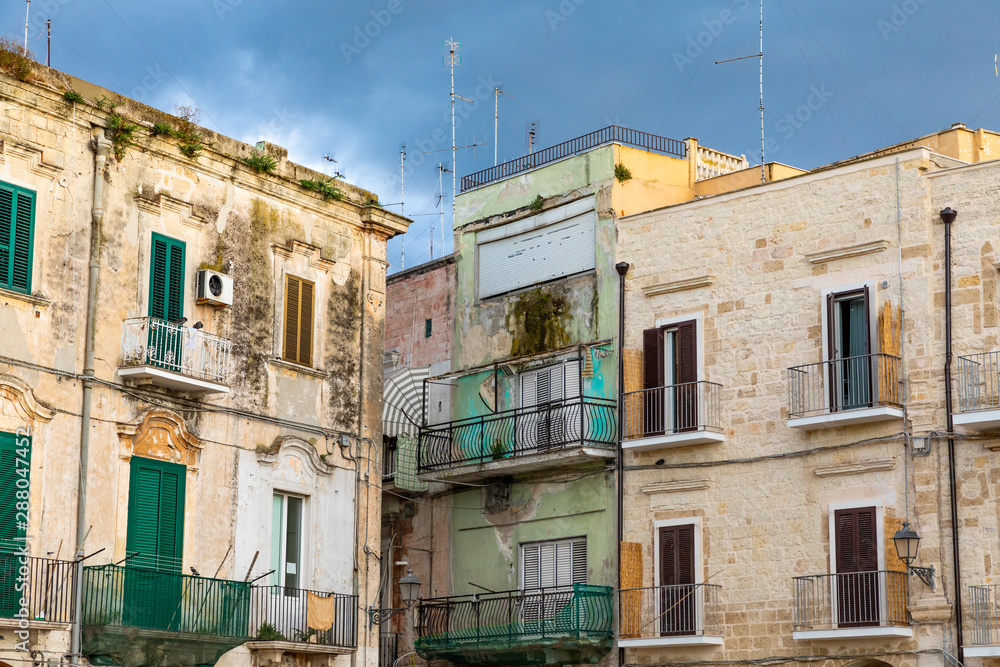 Italy, Apulia, Metropolitan City of Bari, Bari. Old buildings with balconies and shuttered windows and TV antennas.