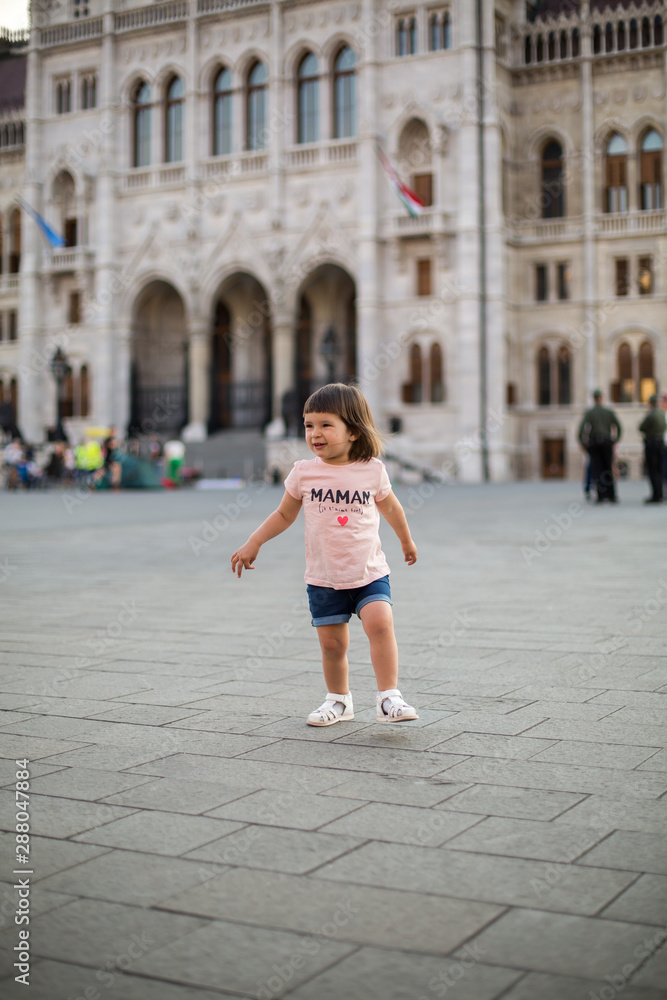 little girl child in shorts and a t-shirt stands near the Hungarian Parliament in Budapest 1 little girl child in shorts and a t-shirt stands near the Hungarian Parliament in Budapest 1