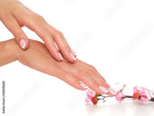 Smooth and well moisturized female hands on white background.