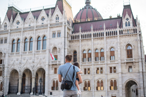 dad and little daughter are walking in the square near the Hungarian Parliament 1