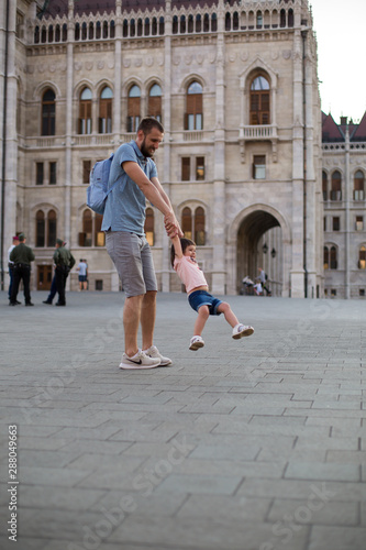 dad and little daughter are walking in the square near the Hungarian Parliament 1