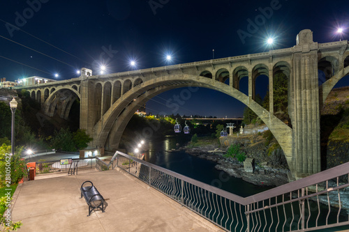 Late night at Spokane Falls along the river with the skyride gondolas, the river, cityscape and the viewing terrace at Riverfront Park, Spokane Washington photo
