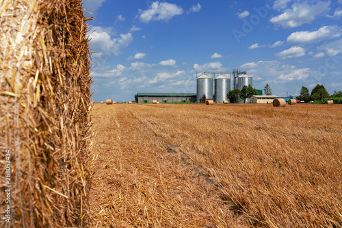 Agricultural Grain Bins in a Farm Field After Harvest