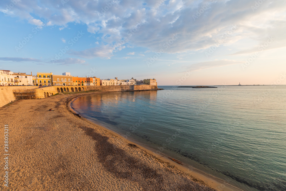 Italy, Apulia, Province of Lecce, Gallipoli. Sunset light on the old city waterfront on the Ionian Sea.