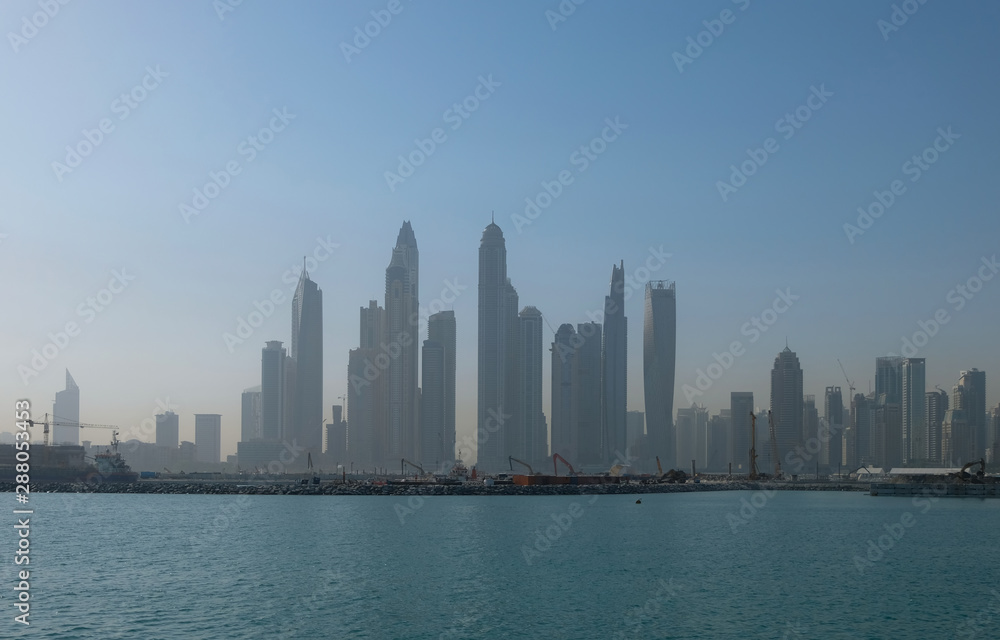 Dubai marina in a morning haze. View from Jumeirah island. May. 2019