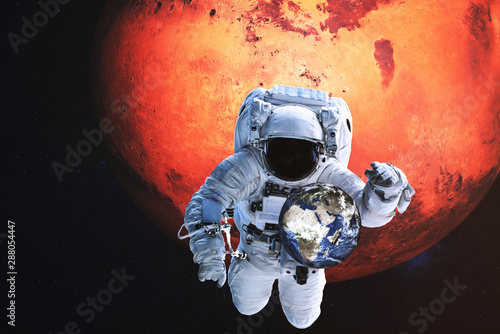 Astronaut in a front of Earth with flying shuttle near Mars planet. Elements of the image were furnished by NASA
