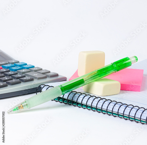 SCHOOL MATERIAL, BOLIGRAPH, DRAFT, NOTEBOOK AND CALCULATOR ON WHITE BACKGROUND. BACK TO SCHOOL