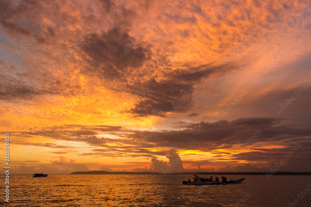 The sky burns! Beautiful sunset over the sea somewhere at Mentawai, Indonesia