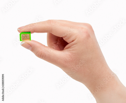 Woman hand holding a new telephony sim card isolated on a white background