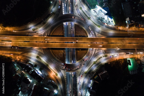 Aerial view night roundabount traffic road with car light movement