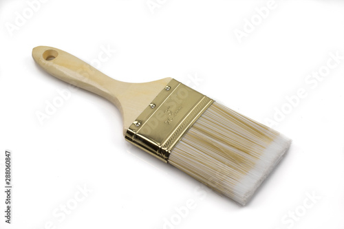 A close up image of a paint brush isolated on a clean, white background