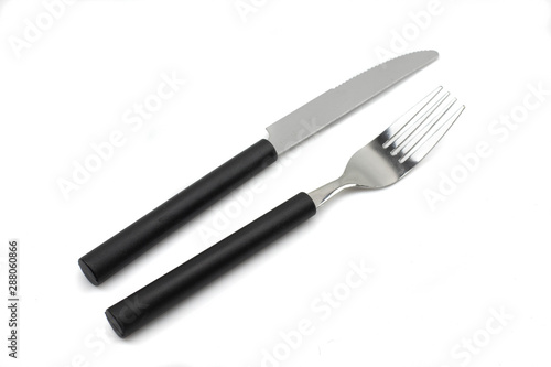 A black handled  silver knife and fork  shot close up in macro  on a clean white background