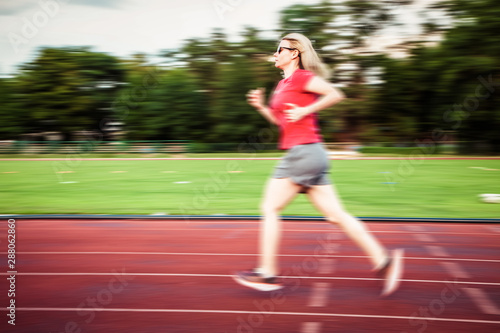 young woman on running track motion blur