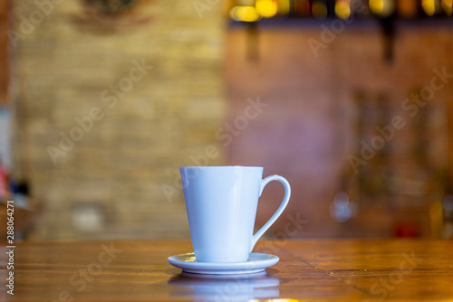 White coffee cup on the bar of a bar - restaurant. Front view.