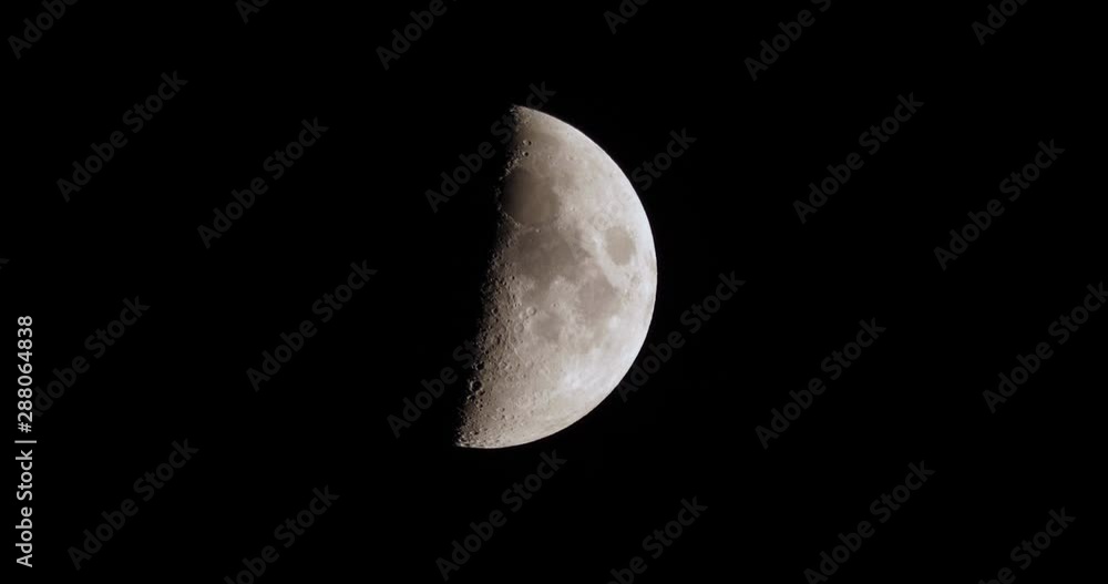 A realtime shot of the half moon in the night sky. A realtime shot of the half moon in the night sky.