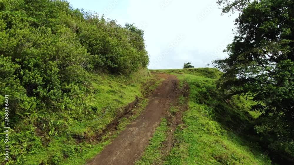 Aerial drone close-up following dirt road through the northern highlands of Costa Rica Aerial drone close-up following dirt road through the northern highlands of Costa Rica