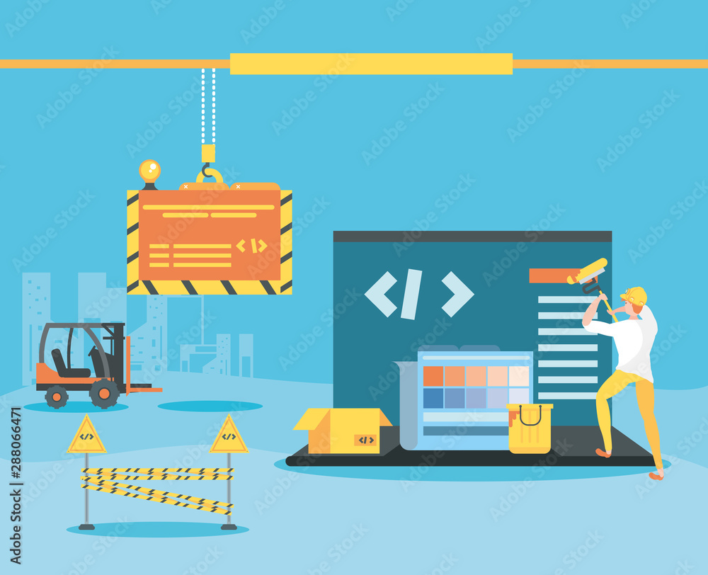 Fototapeta premium builder and laptop with webpage under cosntruction